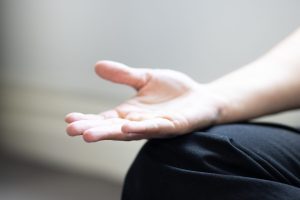 An osteopath's meditating in the treatment room between patient visits.