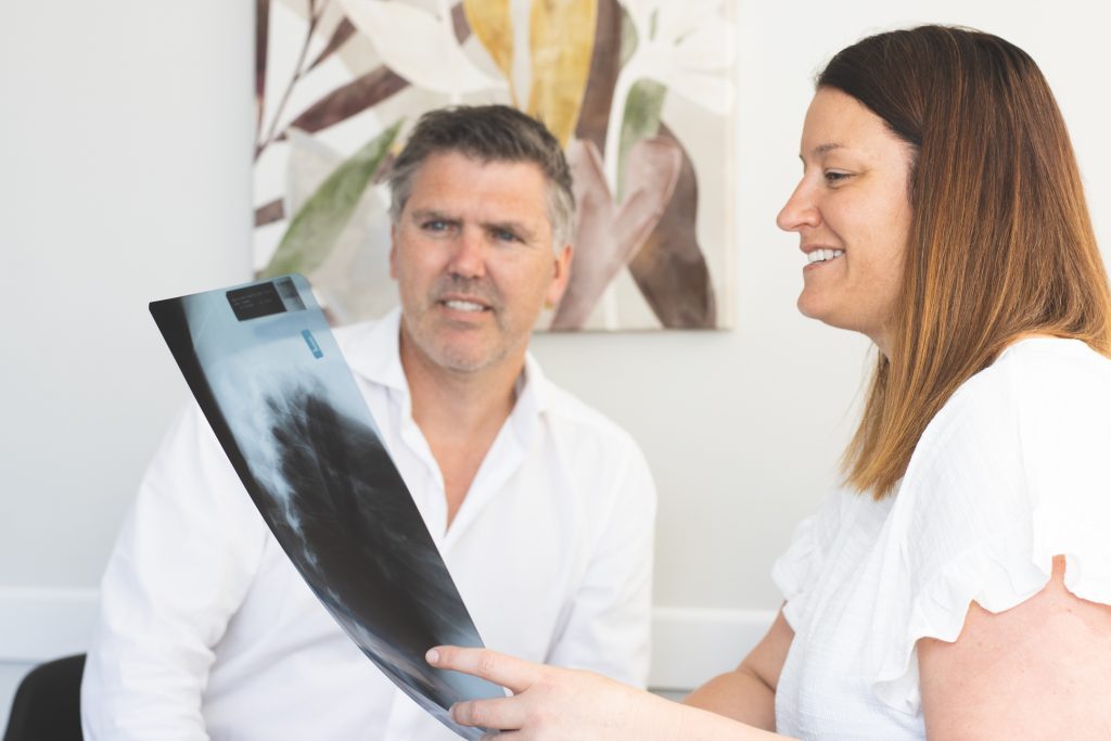Two osteopaths discussing a patient's x-ray.